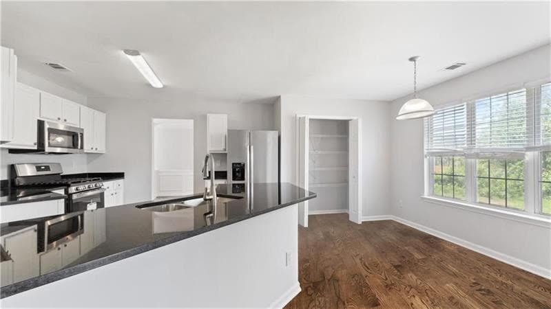 Renovated kitchen with granite counters and a breakfast bar
